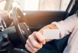 man-showing-business-card-car_23-2147986237